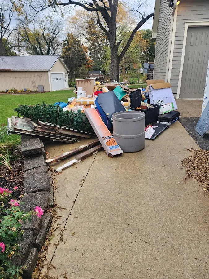 Dumpster being loaded with debris for 10 Yard Dumpster Rental in New Prague